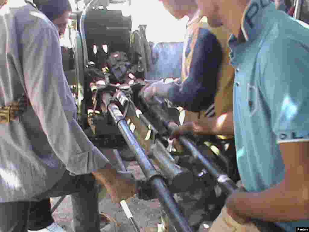 Members of the Free Syrian Army are seen with weapons activists say were taken from forces loyal to Syria's President Bashar al-Assad, after clashes in Saida near Dara, Syria, September 18, 2012.