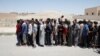 FILE - A group of alleged Islamic State members, pardoned by the Civil Council of Raqqa, are seen during an earlier pardoning ceremony in Ain Issa village, north of Raqqa, Syria, June 24, 2017.