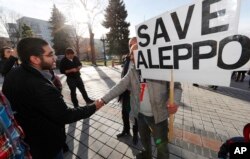 Restaurateur Obeid Kaifo, left, greets a supporter after a protest outside the State Capitol in downtown Denver, Dec. 13, 2016. Protesters joined forces with four state lawmakers calling for the United States to take action to protect the people of Aleppo, Syria. Kaifo said he'd lost four relatives in the fighting there.