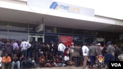 Customers waiting for their turn to withdraw money from the Bulawayo branch of the Metropolitan Bank