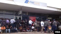 Customers waiting for their turn to withdraw money from the Bulawayo branch of the Metropolitan Bank