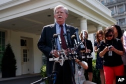 National security adviser John Bolton speaks with reporters outside the White House in Washington about the situation in Venezuela, April 30, 2019.