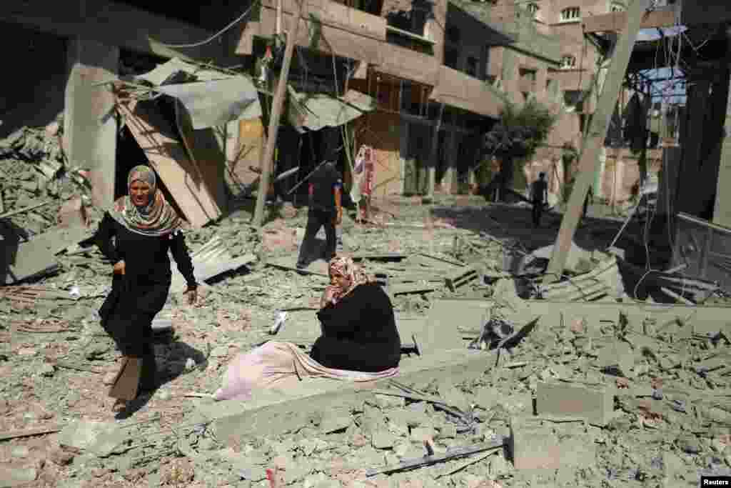 Reconstruction in Gaza, where heavy Israeli bombardment in a war with Islamist militants has caused widespread devastation and displaced half a million people, will cost at least $6 billion, the Palestinian deputy prime minister says. A Palestinian woman