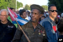 Ernesto Barbon, a veteran of the Angola war where Cuban troops fought in the 80s, waits in line to enter the Revolution PLaza, to render homage to Fidel Castro in Havana, Cuba, Nov. 28, 2016.