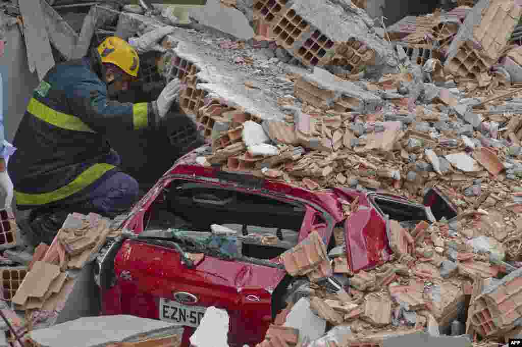 Rescuers work amid the rubble of a building in construction that collapsed killing a least six people and injuring at least 22 in Sao Paulo, Brazil.