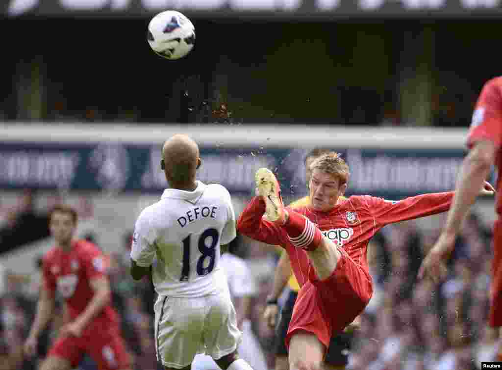 Tottenham Hotspur's Jermain Defoe (L) challenges Southampton's Steven Davis for the ball during their English Premier League soccer match at White Hart Lane in London.