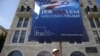 An Israeli youth walks past a poster welcoming and supporting US President Donald Trump in downtown Jerusalem, on May 19, 2017.