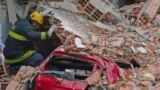 Rescuers work amid the rubble of a building in construction that collapsed killing a least six people and injuring at least 22 in Sao Paulo, Brazil.