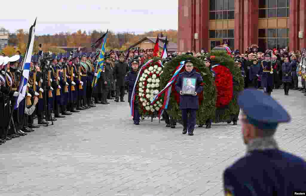 Officers carry the coffin of late cosmonaut Alexei Leonov, the first man to conduct a space walk in 1965, during his funeral in Mytishchi, outside Moscow, Russia.