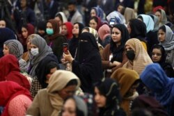 FILE - Afghan women attend an event to mark International Women's Day in Kabul, Afghanistan, March 7, 2021.