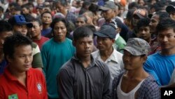 Burmese fishermen wait for their departure to leave the compound of Pusaka Benjina Resources fishing company in Benjina, Aru Islands, Indonesia, April 3, 2015.