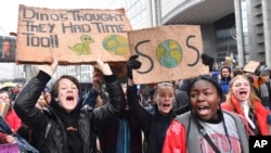 Protesters hold banners as they march during a "Rise for the Climate" demonstration in Brussels, Belgium, Jan. 27, 2019.
