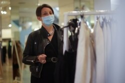 A person shops inside a clothing store amid the coronavirus (COVID-19) pandemic in London on July 6, 2021.