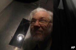Wikileaks founder Julian Assange leaves in a prison van after appearing at Westminster Magistrates Court for an administrative hearing in London, Jan. 13, 2020.