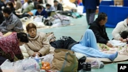 Evacuees gather in a gym in Koriyama, Japan