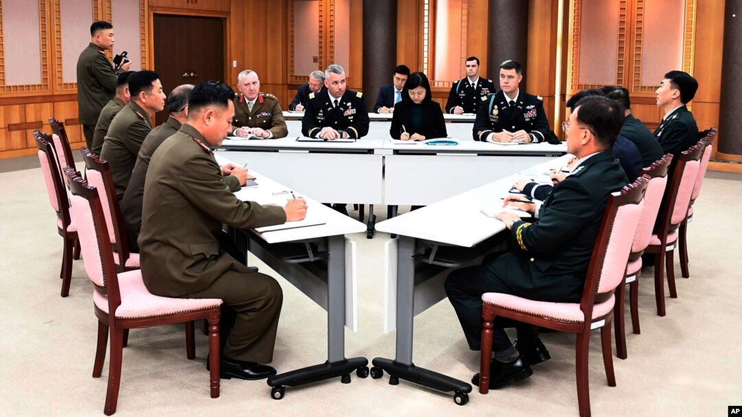  In this Oct. 16, 2018, photo provided by S. Korea Defense Ministry, the U.S.-led UNC, center, S. Korean and N. Korean, left, military officers attend a meeting at the southern side of Panmunjom in the DMZ, South Korea. 