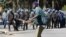A demonstrator reacts after anti-riot police use batons to break up a peaceful march protesting the Zimbabwe government's handling of the economy, in Harare, Aug. 3, 2016.