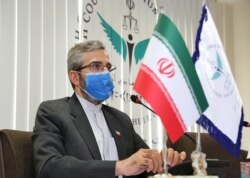 FILE - This handout picture provided by Iran's High Council for Human Rights on May 29, 2021 shows the organization's deputy secretary Ali Bagheri Kani at its premises in the capital Tehran. (Iran's High Council for Human Rights / AFP)