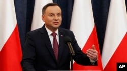 FILE - Poland's President Andrzej Duda speaks at a news conference in Warsaw, Poland, Dec. 20, 2017.