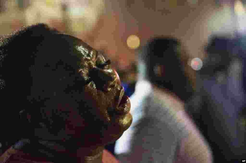 Lisa Doctor joins a prayer circle down the street from the Emanuel AME Church early Thursday, June 18, 2015.