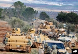 FILE - Turkish troops take control of Bursayah hill, which separates the Kurdish-held enclave of Afrin from the Turkey-controlled town of Azaz, Syria, Jan. 28, 2018.