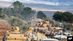 FILE - Turkish troops take control of Bursayah hill, which separates the Kurdish-held enclave of Afrin from the Turkey-controlled town of Azaz, Syria, Jan. 28, 2018.