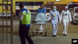 Medical staff push a metallic bed, which is used for transporting bodies, from the forensic department at Kuala Lumpur Hospital in Kuala Lumpur, Malaysia, Feb. 19, 2017.