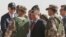 Jordan's King Abdullah II, center, and U.S. Vice President Joe Biden, left, visit a joint Jordanian-American training center at Zarqa, northeast of Amman, Jordan, March 10, 2016.