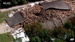 Whiskey barrels are piled in a heap, July 4, 2018, after the rest of the Barton 1792 Distillery, a whiskey storage warehouse, collapsed in Bardstown, Kentucky, nearly two weeks after part of the decades-old structure came crashing down.