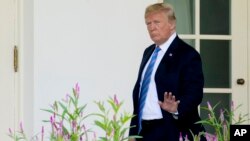 Presiden Donald Trump melambaikan tangan ke arah wartawan saat keluar dari Sayap Barat Gedung Putih di Washington, 18 Juli 2018.