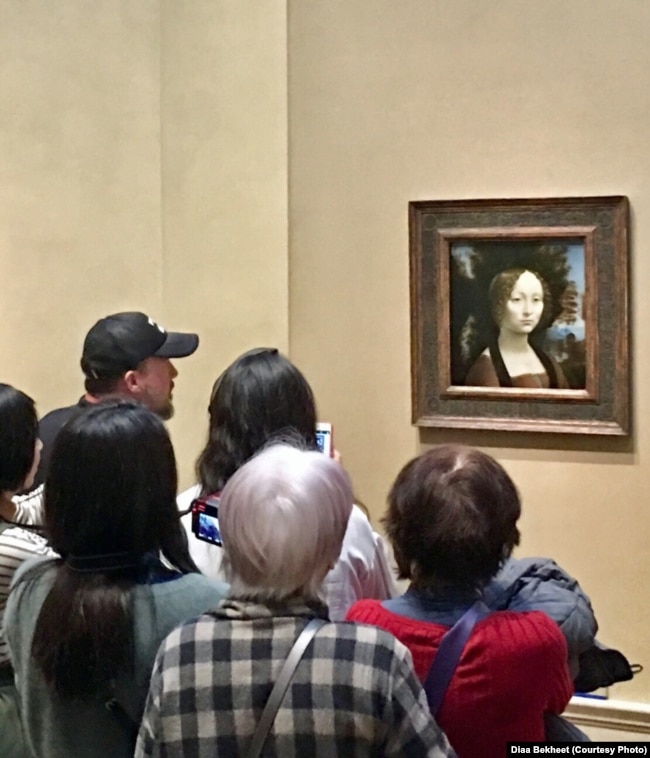 Tourists take pictures of Ginevra de' Benci, the original portrait painting by Leonardo da Vinci of the 15th-century Florentine aristocratic teenager. The National Gallery of Art in Washington bought it in 1967 for $5 million, a huge price at the time. (Photo: Diaa Bekheet)