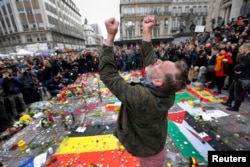 A man reacts at a street memorial following Tuesday's bomb attacks in Brussels, March 23, 2016.