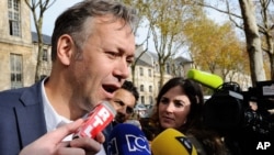 Karim Benzema's lawyer Sylvain Cormier answers questions as he meets the media in front of a police station in Versailles, south of Paris, France, where his client is being questioned, Nov. 4, 2015.