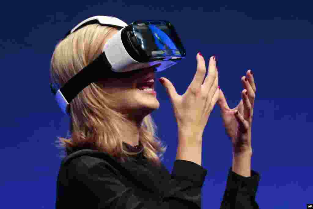 British television presenter Rachel Riley shows a virtual-reality headset called Gear VR during an unpacked event of Samsung ahead of the consumer electronic fair IFA in Berlin, Germany.
