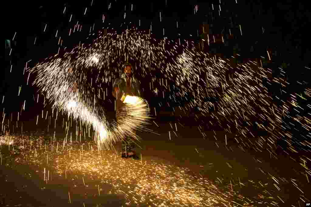 A Palestinian plays with fireworks as he celebrates the start of the Muslim holy month of Ramadan in the West Bank city of Nablus.