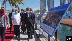 Sri Lankan President Gotabaya Rajapaksa, left, and Chinese Foreign Minister Wang Yi arrive at the Chinese funded sea reclamation Port City project in Colombo, Jan. 9, 2022.