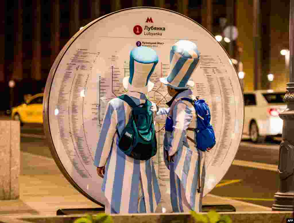 Argentina fans look at a metro map in downtown Moscow ahead of the Russia 2018 World Cup football tournament.