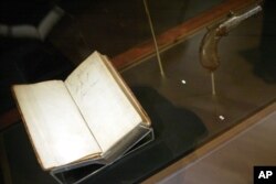 Charles Darwin's bible and pistol are on display during a press preview of "Darwin" at the American Museum of Natural History in New York, Nov. 15, 2005.