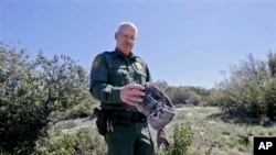 California Border Patrol agent Richard Gordon holds a carpet and wire wrap which illegal immigrants use to disguise their footprints after entering the U.S., March 25, 2013.