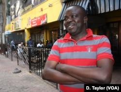 Freddy Lendo, with his Congolese friends in the background, enjoys watching AFCON matches at a bar full of DRC nationals.