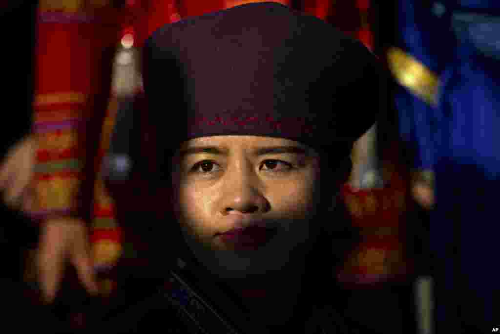 An ethnic minority delegate poses for a group photo with other delegates before a plenary session of the National People&#39;s Congress (NPC) at the Great Hall of the People in Beijing.