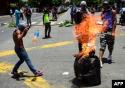 Anti-government activists demonstrate against Venezuelan President Nicolas Maduro at a barricade set up on a road in Caracas on Aug. 8, 2017.