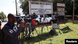 Journalists wait outside the Director of Criminal Investigation headquarters, following the arrest of several officials over corruption in Nairobi, Kenya May 28, 2018. 