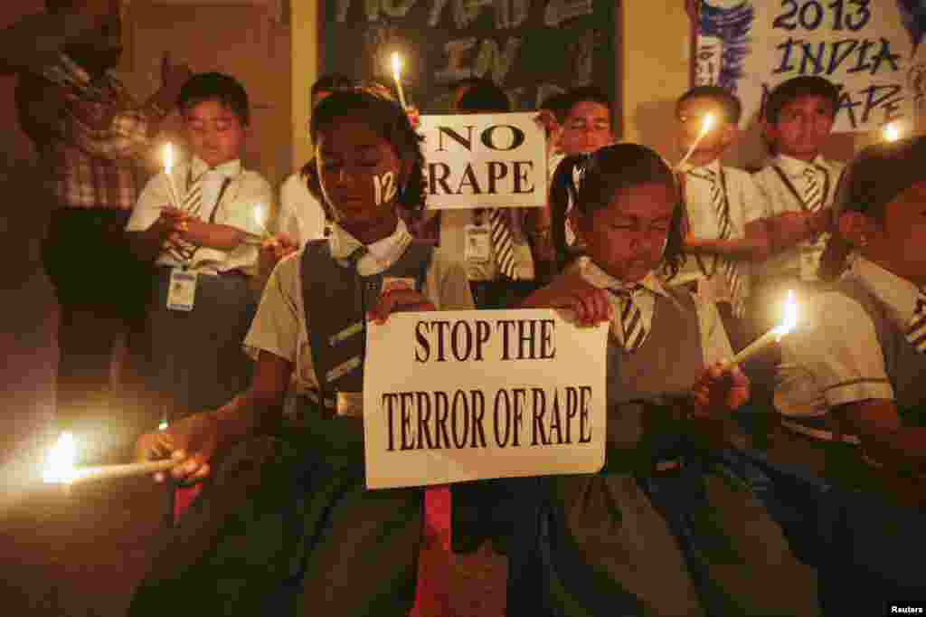 Students hold candles as they pray during a candlelight vigil for a gang rape victim, who was assaulted in New Delhi and later died, in Ahmedabad, India, December 31, 2012.