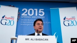 FILE - Ali Babacan, deputy prime minister at the time, is seen speaking during a news conference at the International Monetary Fund and World Bank meetings in Washington, April 17, 2015.