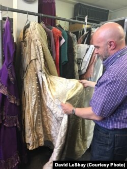 Costume collection director Stephen Cabral looks at a gown worn by soprano Beverly Sills in a Met production of Lucia di Lammermoor.