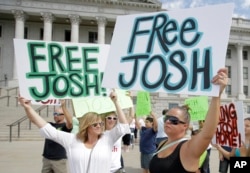 FILE - People show their support for Joshua Holt, an American jailed in Venezuela, during a rally at the Utah State Capitol, in Salt Lake City, July 30, 2016.