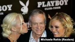 FILE - Playboy magazine founder Hugh Hefner seen here with Kendra Wilkinson (L) and Bridget Marquardt for his 80th birthday party on May 31, 2006. (REUTERS/Michaela Rehle/File Photo)