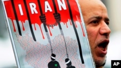 An Iranian exile shouts slogans to protest against executions in Iran during a demonstration in front of the Iranian embassy in Brussels. (file) 