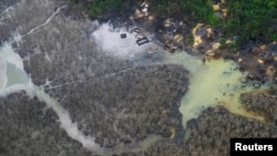 FILE - An aerial view shows illegal refineries and pollution among the waterways in Rivers State, Nigeria, June 19, 2017. 